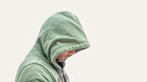 a man hiding in hoodie